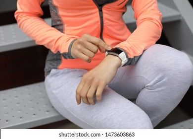 Detail of sporty woman checking workout goals on fitness tracker. Female athlete getting ready for running. Sport and healthy lifestyle technology concept. - Powered by Shutterstock