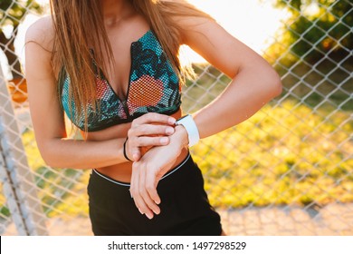 Detail Of Sporty Woman Checking Workout Goals On Fitness Tracker. Female Athlete Getting Ready For Running. Sport And Healthy Lifestyle Technology Concept.Young Fit Woman Using Smart Watch 