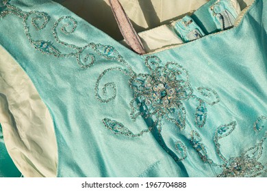 Detail Of Square Neckline And Armhole Of A Elegant Cocktail Aquamarine Dress With Embrodery In Transparent Beads And Paillettes