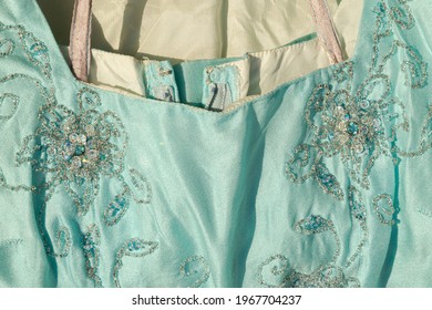 Detail Of Square Neckline Of A Elegant Cocktail Aquamarine Dress With Embrodery In Transparent Beads And Paillettes