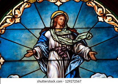 Detail of stained glass window depicting Catholic doctrine of Assumption of Blessed Virgin Mary into Heaven