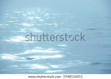 Detail of a sunlight reflecting in glittering sea. sparkling in water - background. sea water with sun glare and ripple. Powerful and peaceful nature concept.