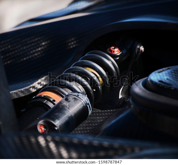Detail of supercar car cushioning system.\
Carbon fiber chassis and suspension\
arm.