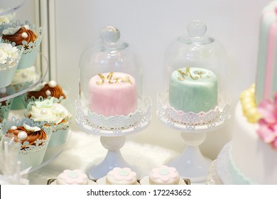 Detail Of Sweet Table On Wedding With Cupcakes And Bride And Groom Cakes