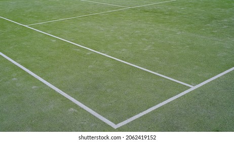 detail of synthetic tennis court. white lines on green