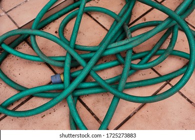 Detail Of A Tangled Hose On A Terrace.