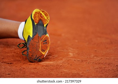 Detail With A Tennis Shoe Sole On A Tennis Clay Court