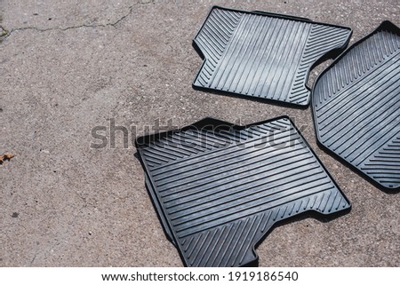 Image, Stock Photo Three rubber floor car mats lying on the street ground. Car interior cleaning concept