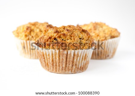 Detail of three gluten free muffins with nuts isolated on white background