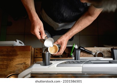 Detail of top view of Caucasian man pouring milk in a cup of coffee - Powered by Shutterstock