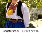 A Detail of a traditional Dalmatian Croatian costume from Cilipi, Dubrovnik. A girl wearing a folklore outfit with colorful embroidery. Authentic, cultural historic clothing from Croatia