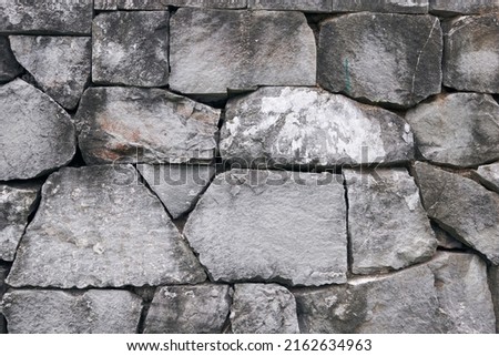 Detail of a traditional stonewall of Japanese building. Cut stone wall background.