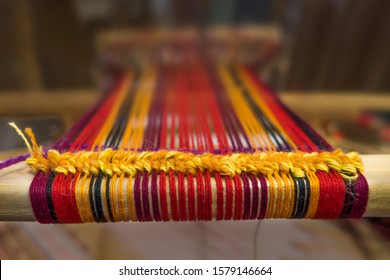 Detail of traditional vintage weaving hand loom with wool close up. Weaving background. Craftsmanship background. Traditional old loom.