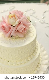 Detail Of Traditional Wedding Cake With Pink And Cream Roses.