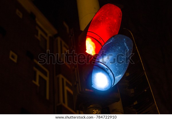 Detail of a traffic\
light with a red and a white light. This traffic indicator is\
located in Amsterdam.