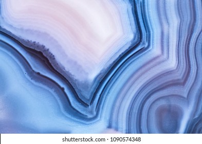 Detail of a translucent slice of natural stone agate. Natural concentric patterns and textures of minerals for background. Natural stone agate surfaces, backgrounds and wallpapers.