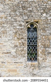 Detail of the trefoiled top, lancet window in the exterior wall of the Church of St Oswald's, Swinbrook and Widford, Oxfordshire, England - Shutterstock ID 2089554451