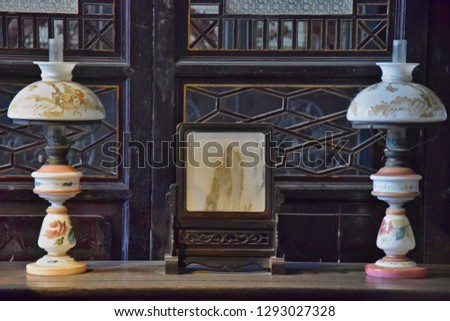 Detail of two oil lamps. Traditional room of wealthy chinese family. Interior with antique wooden furniture. 