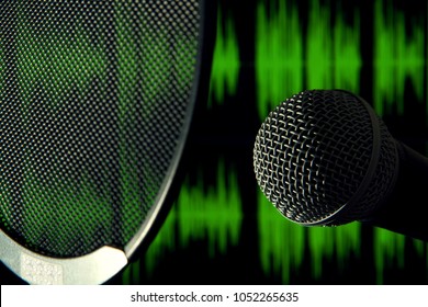 Detail view of microphone head with a pop filter in front and green sound waves on the background