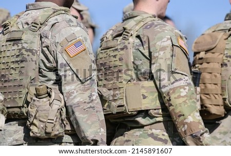 Detail view of the US Army uniform worn by soldiers in a military base. Flag of America on the uniform.