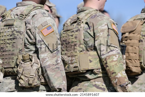 Detail view of the US\
Army uniform worn by soldiers in a military base. Flag of America\
on the uniform.