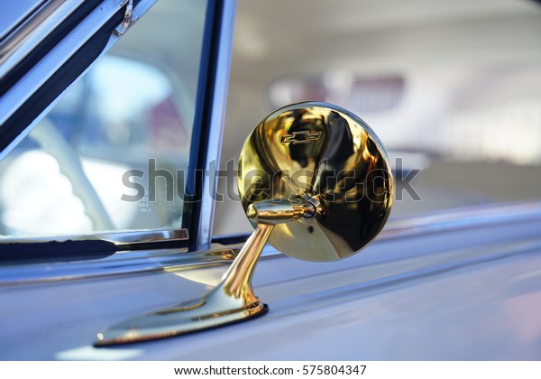 Detail of a vintage car rear mirror in gold color -\
Las Vegas - January 2017