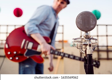 Detail Of A Vintage Old Microphone Isolated On A Festival Background. Live Music Concept. Intimate Concert About To Start. Musicians Rehearsing And Testing Sound Conditions Before Performing.