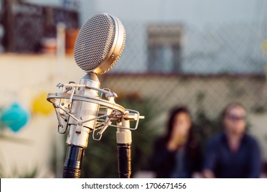 Detail Of A Vintage Old Microphone Isolated On A Festival Background. Live Music Concept. Intimate Concert Abut To Start. Music Outdoors Concept.