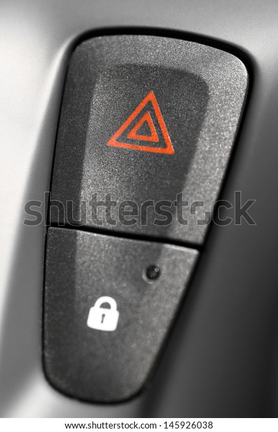 Detail of a warning button\
in a car