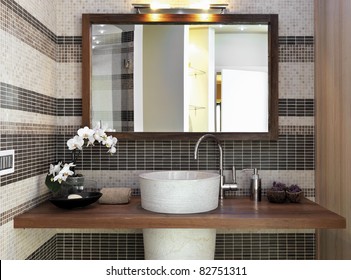 Waschbecken im modernen Badezimmer mit einer Vase aus weißem Ocker