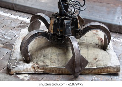 Detail of waste plant: Old mattress with large claw on conveyor belt - Powered by Shutterstock