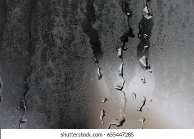 Detail Of Water Dripping Down Glass.