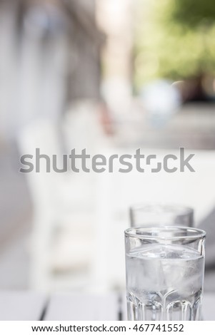 detail of a water in a glass cup with ice. space for lettering, copy and text