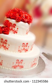 Detail Of Wedding Cake With Red Roses