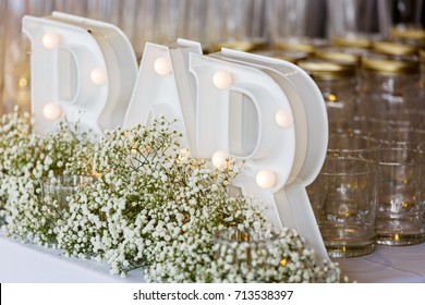 A detail of wedding decoration display with bar electric sign, glass 
