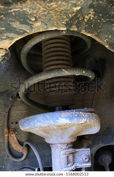 Detail of wheel coil damper spring suspension on\
13-years old car