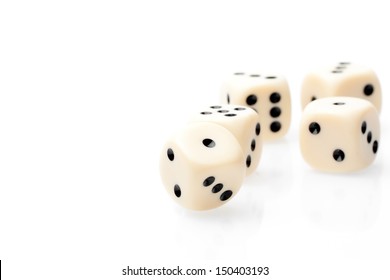 detail of white dice on white table with space for text