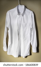 Detail Of White Dress Shirt Hanging On Hanger With Light