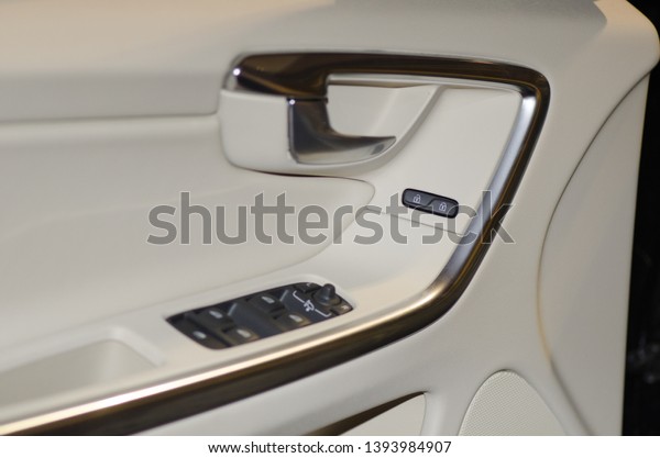 Detail of a white\
leathered luxury car\
door