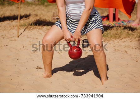 Detail of woman doing exercises on the beach in functional training circuit