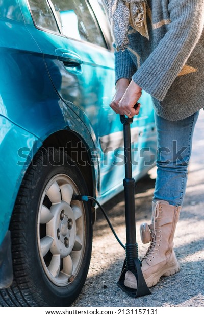 detail of a woman\
inflating a car tyre