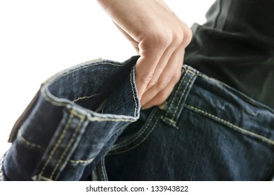 Detail Of Woman Skinny Waist In Too Large Old Jeans. Concept Of Successful Dieting. Shallow Dof.