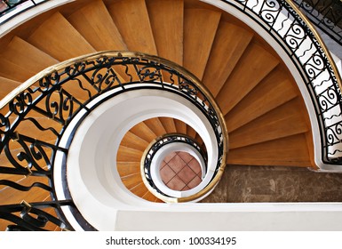 Detail of the wood spiral staircase in the hotel - Powered by Shutterstock