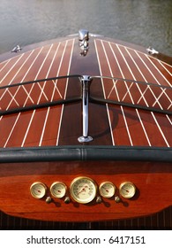 Detail of wooden boat dashboard and windshield.