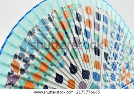 Detail of a wooden fan painted with Andalusian and Arabic motifs