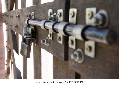 Detail of wooden slats from farm pot, showing the latch and padlock.