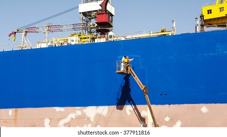 Detail Of Workers Painting Ship Hull