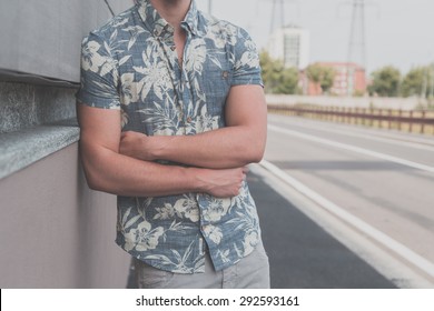 Detail Of A Young Handsome Man Wearing A Short Sleeve Shirt And Posing In An Urban Context