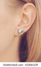 Detail of young woman wearing beautiful luxury earring  - Shutterstock ID 413061139