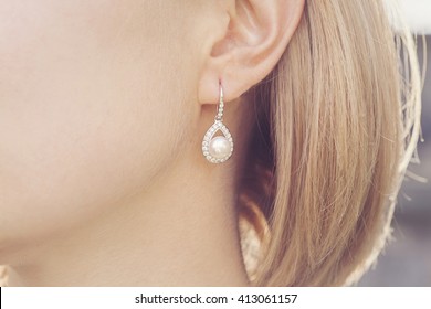 Detail of young woman wearing beautiful luxury earring  - Shutterstock ID 413061157